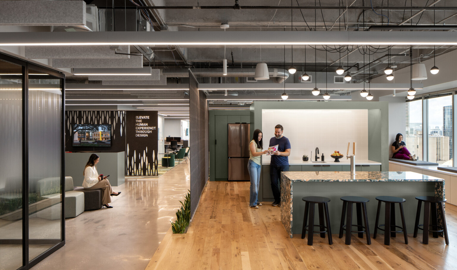 DLR Group orlando office; modern office with open kitchen to lobby space; employees collaborating