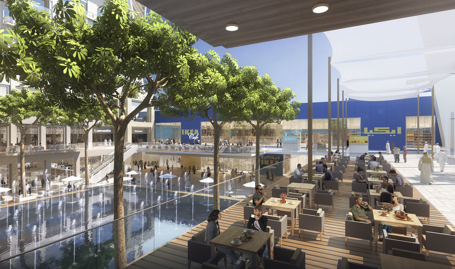 Exterior of an outdoor mall showing seatings areas with a large water fountain in front of a blue wall