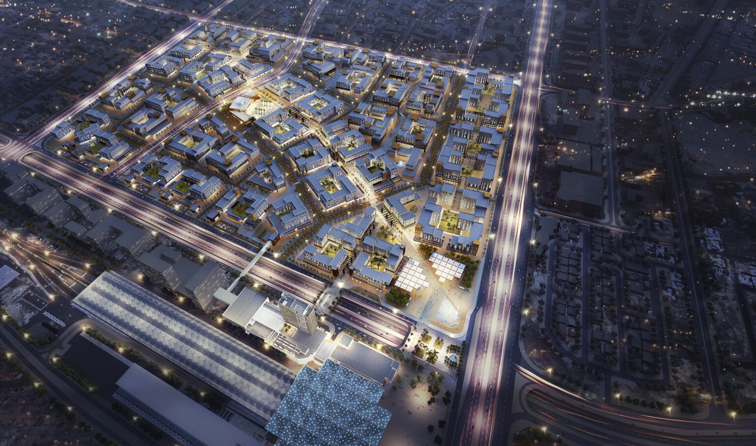 gridded master plan with vehicular street divisions and large commercial buildings with bright lights against dark sky