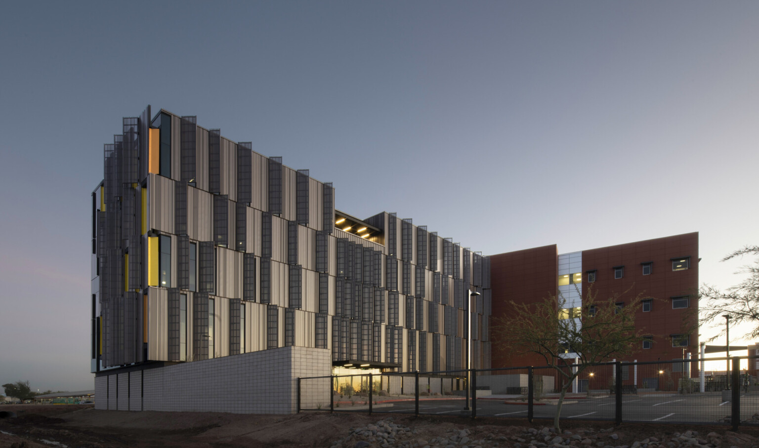 Dusk shot of Pinal County Attorney’s Offices, a serrated wrapped facade in alternating horizontal layers