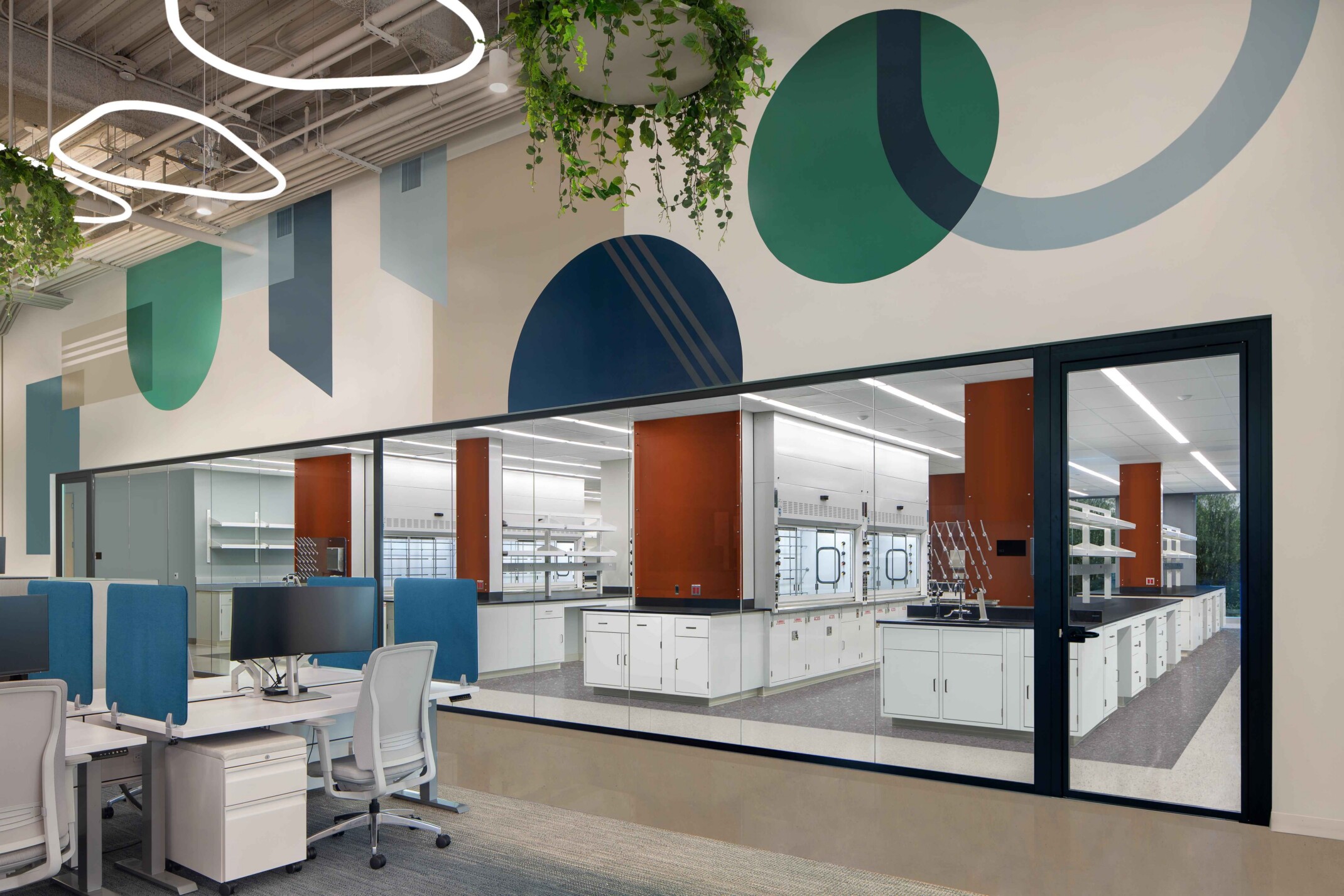 modern science and technology office; colorful cubicle space looks into an open concept lab