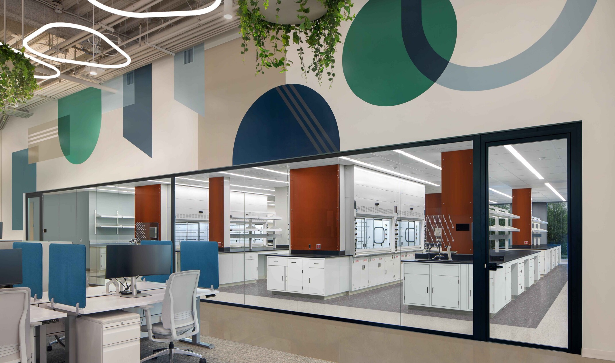 modern science and technology office; colorful cubicle space looks into an open concept lab