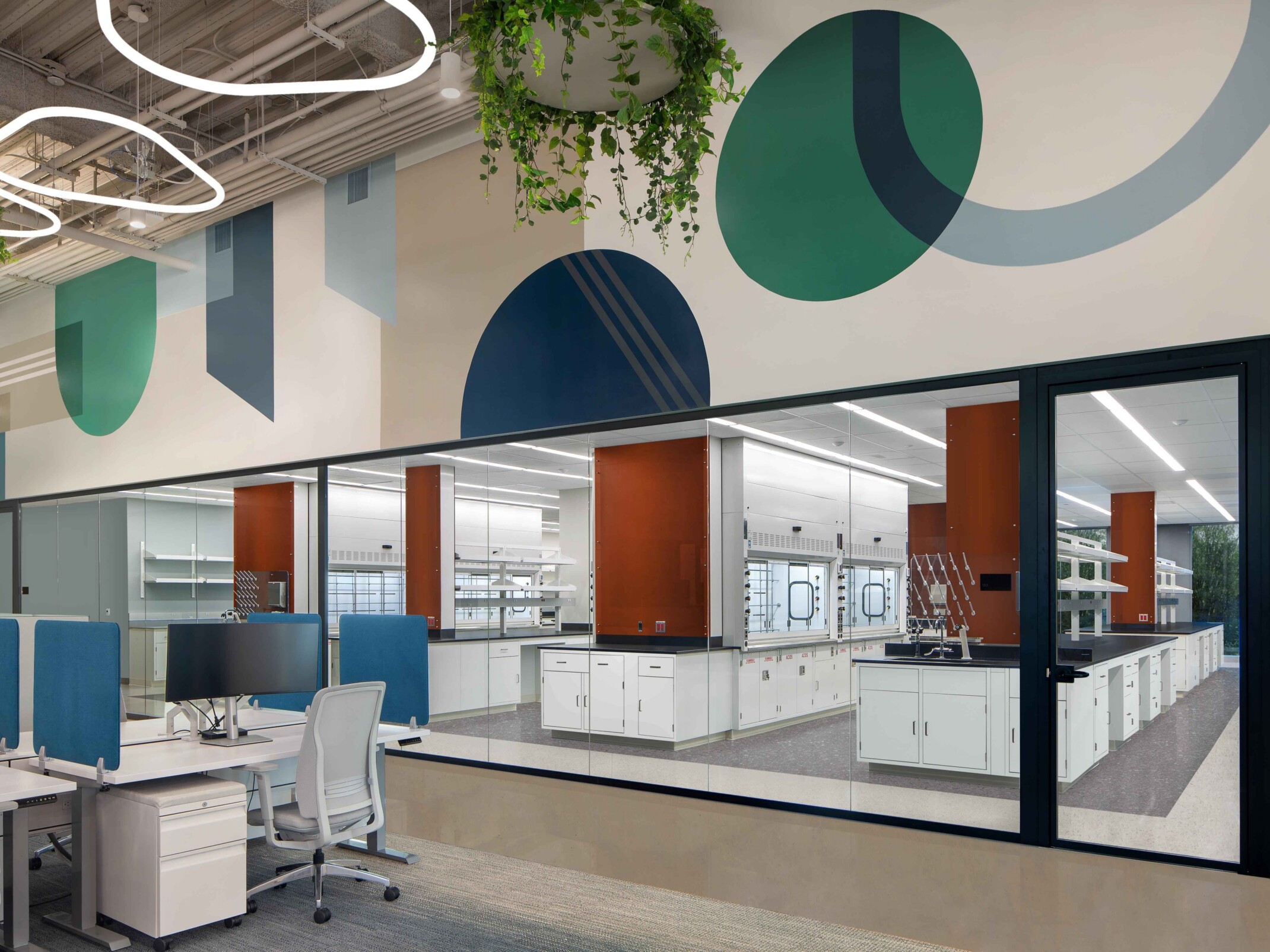 modern science and technology office; colorful cubicle space looks into an open concept lab