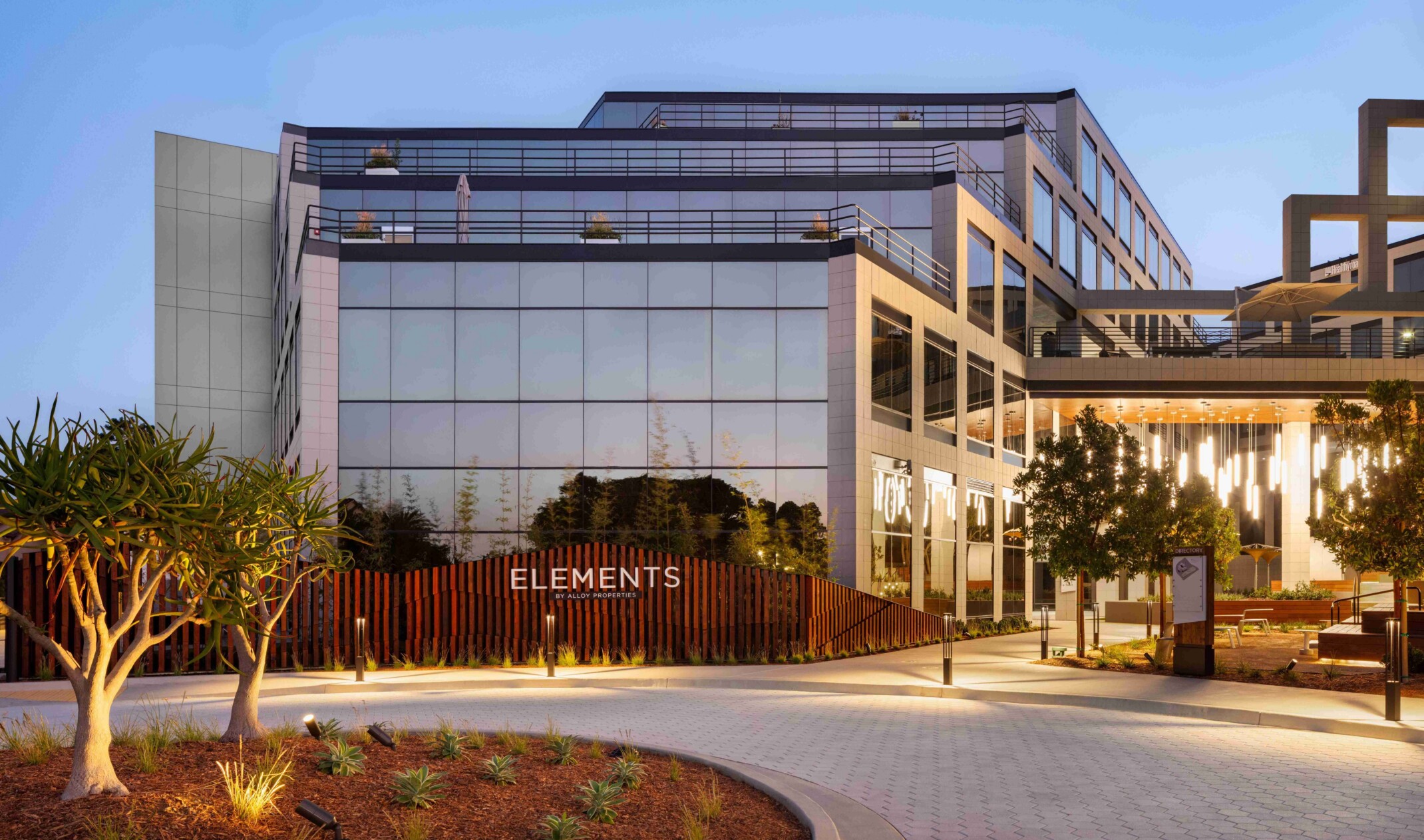exterior of a modern building with a multi-facade treatment with treated glass on all levels for a geometric feel