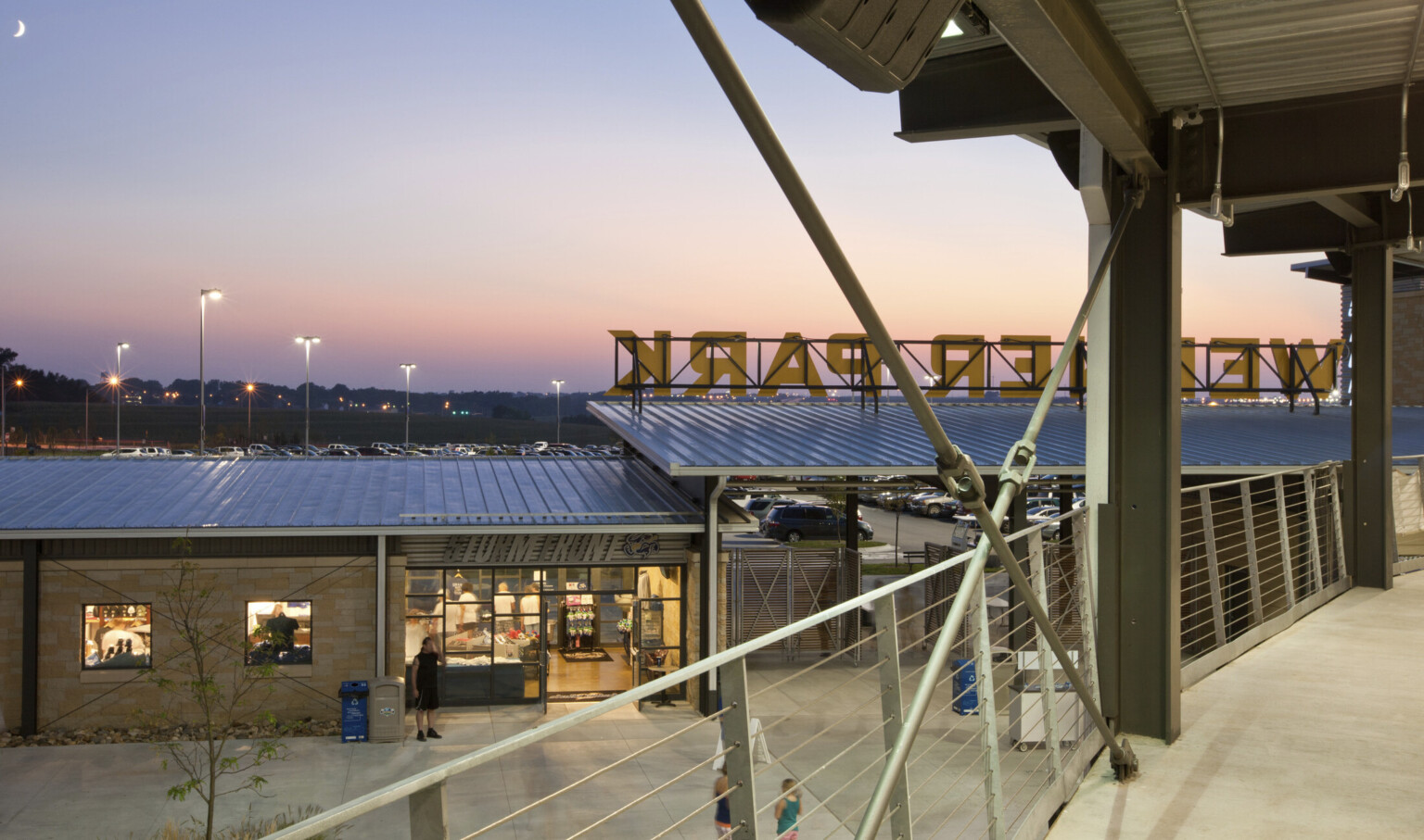 Elevated walkway looking towards back of main entrance. Storm Front store at left of covered gates, with view of parking lot