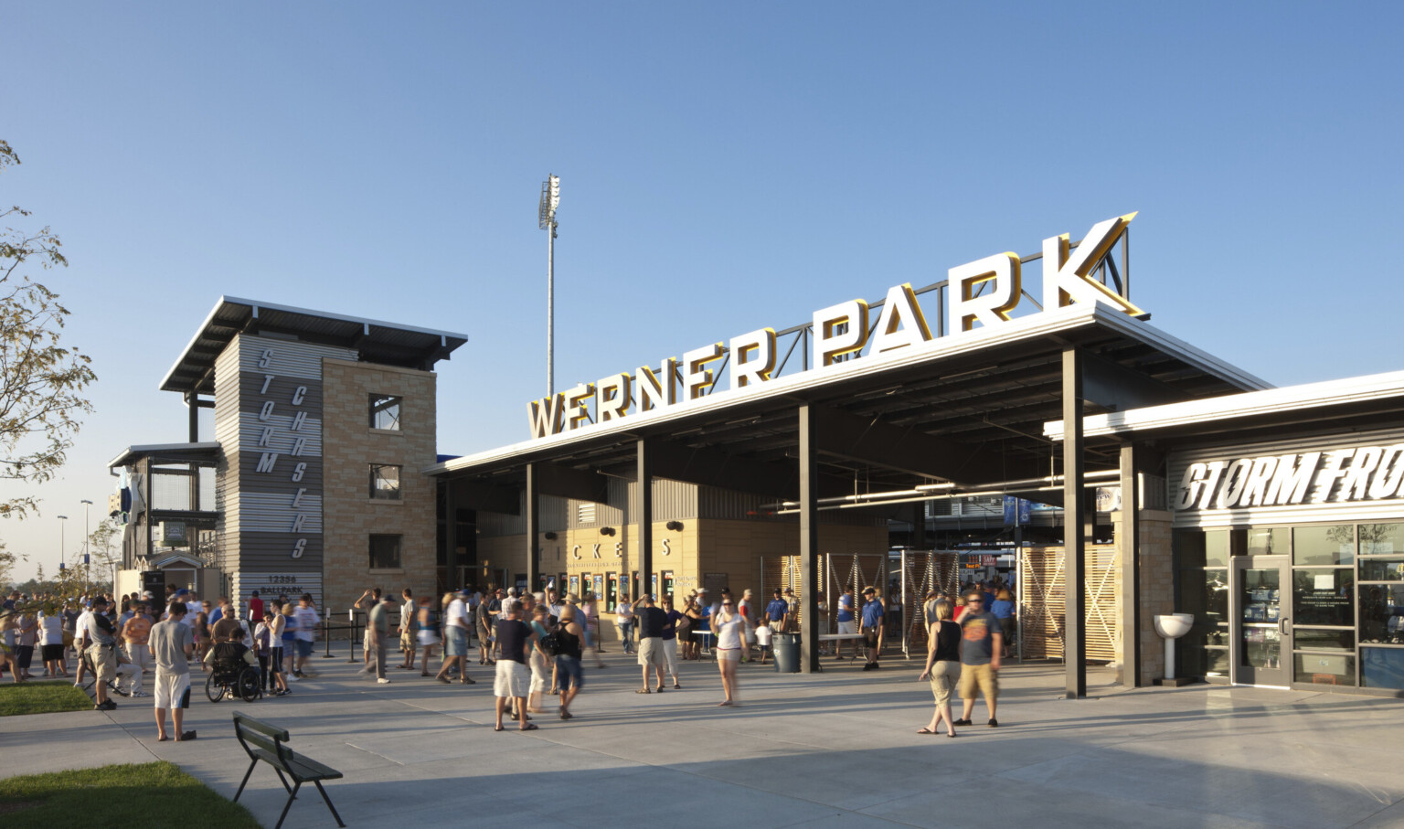 Werner Park entrance with signage above sheltered gates. Ticket windows line wall to left, with Storm Chasers written on side