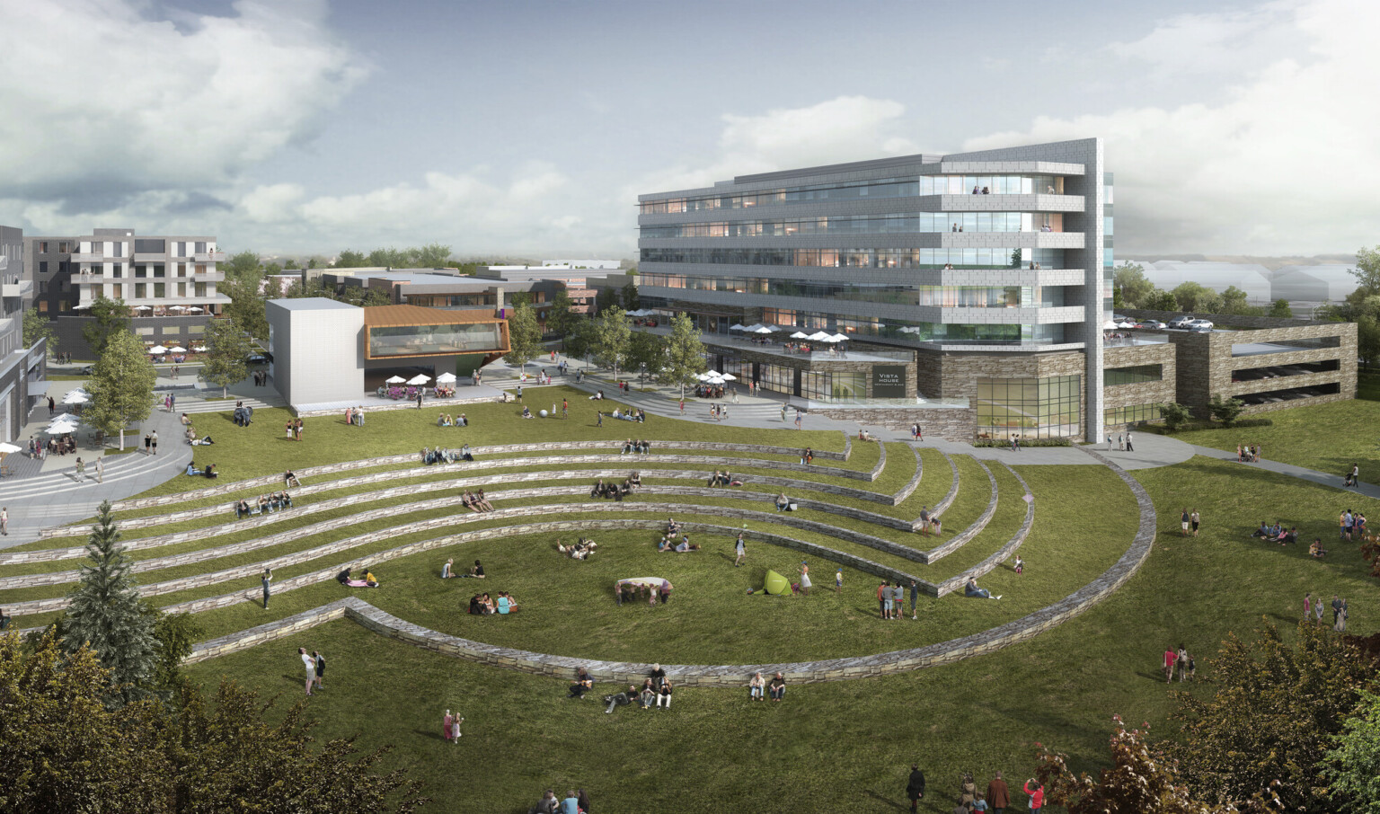 Lawn with grass covered stone stepped bench seating connecting La Vista City Centre shopping district with lake