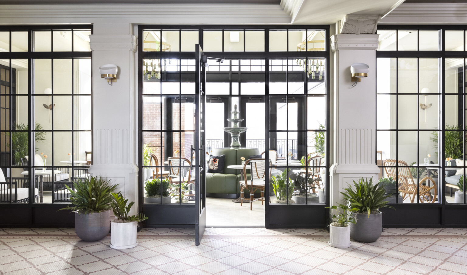 glas doors opening onto a tiered indoor fountain