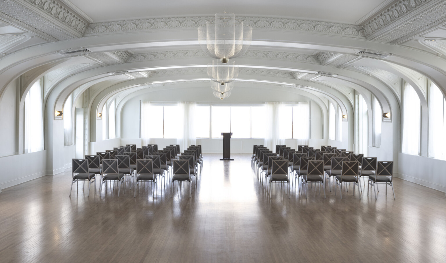 ballroom with white arched ceilings