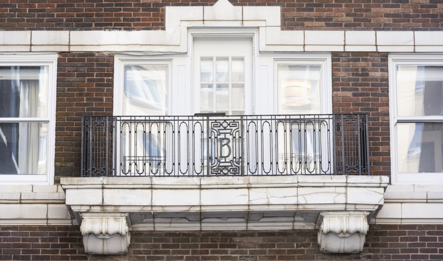 black wrought iron railing with custom monogram