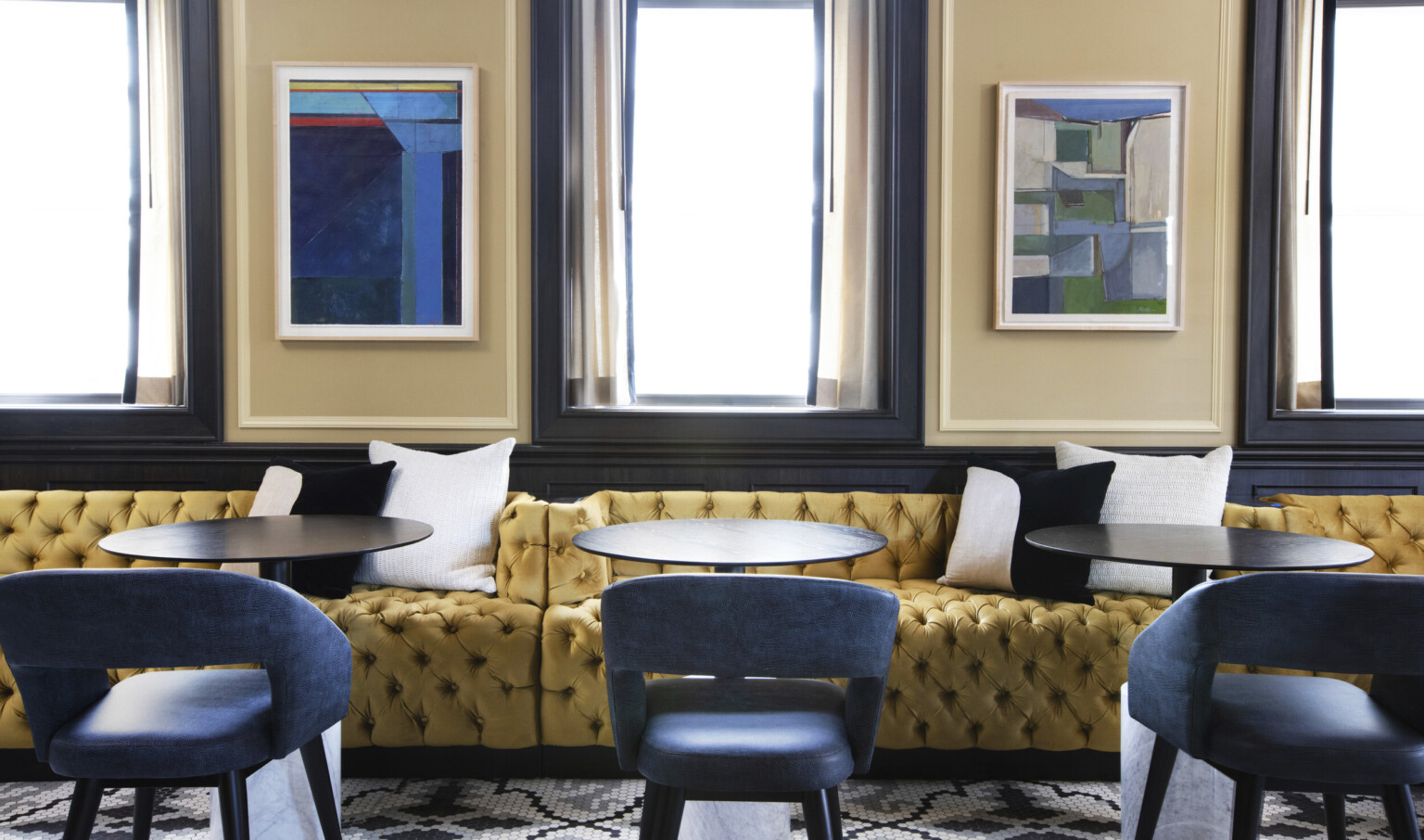 gold banquette seating and blue upholstered chairs