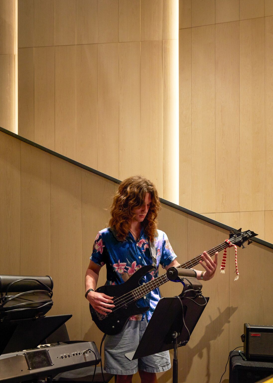 Individual in a blue shirt playing a guitar