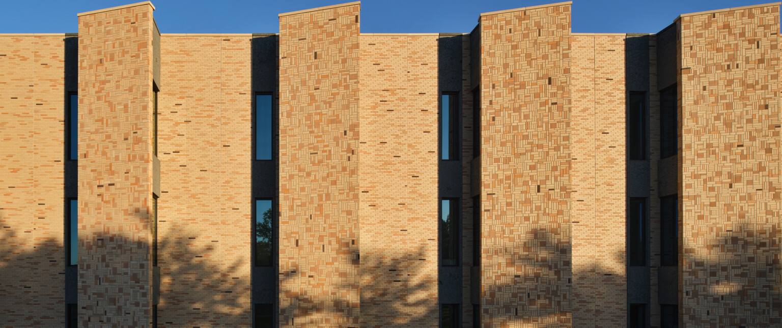 Exterior of a brick building with variations of tan brick color