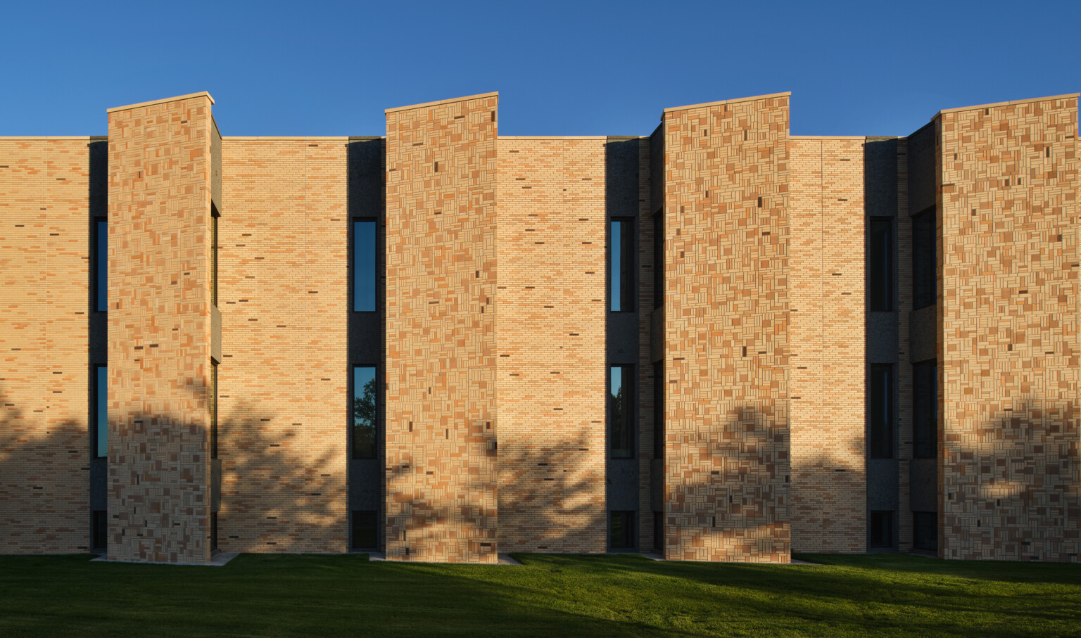 Rendering of a brick building with variations of tan brick color