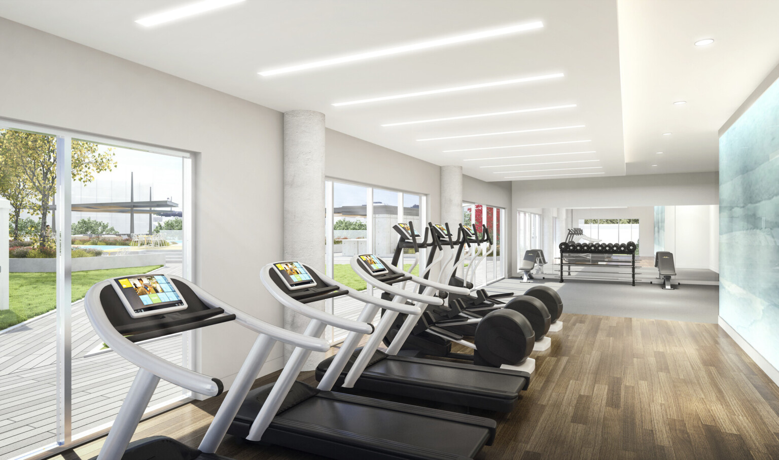 Gym equipment faces large windows with view of courtyard. A white room with drop ceiling detail and recessed light rods