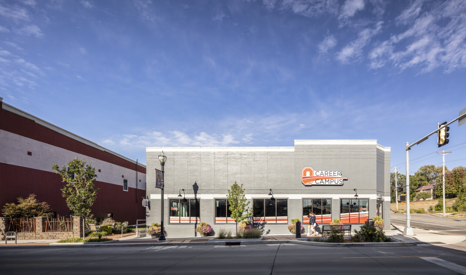 outside image of the Ottumwa career campus; gray building with branded signage and greenery throughout