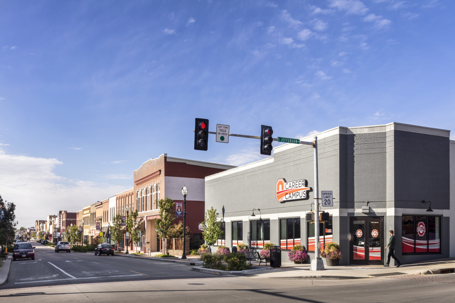 Street view of career campus building from s. jefferson, lighted signage, traffic lights, blue sky, light clouds