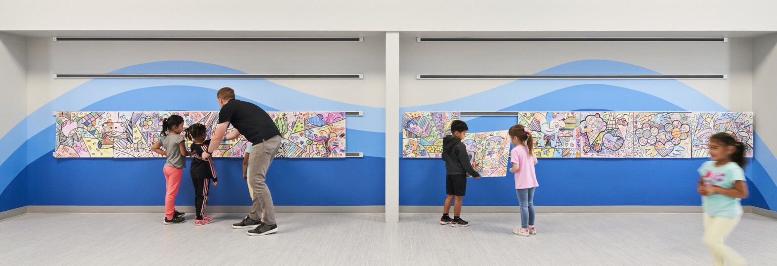 elementary students admiring a painted mural