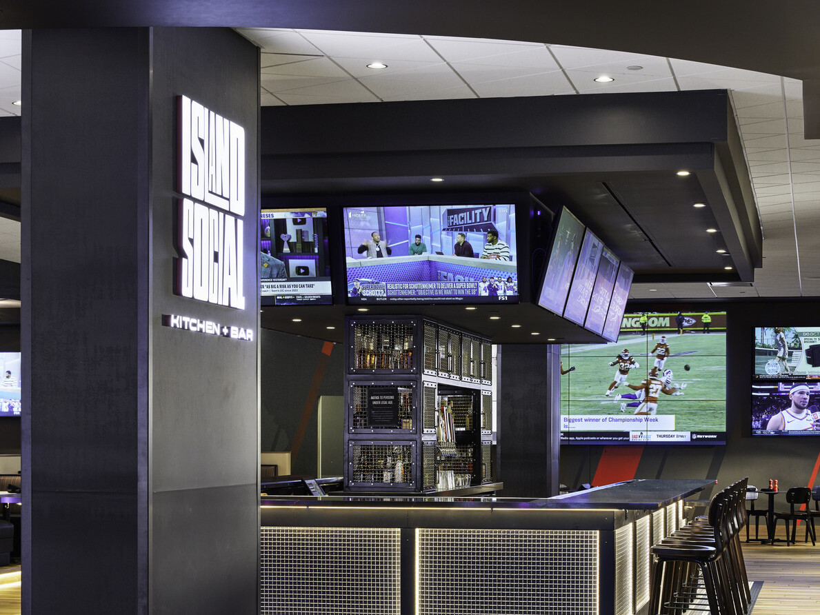 Q Casino sports bar with 360 TVs featuring games; banner marquee highlighting the game schedule