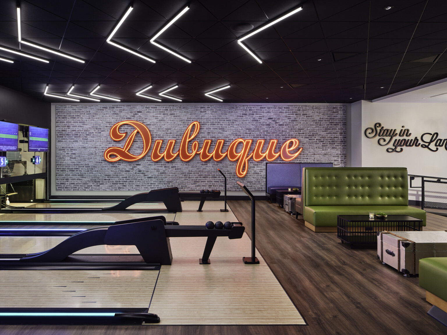 Q Casino feature red LED "dubuque" sign in interactive bowling area; luxury gaming experience
