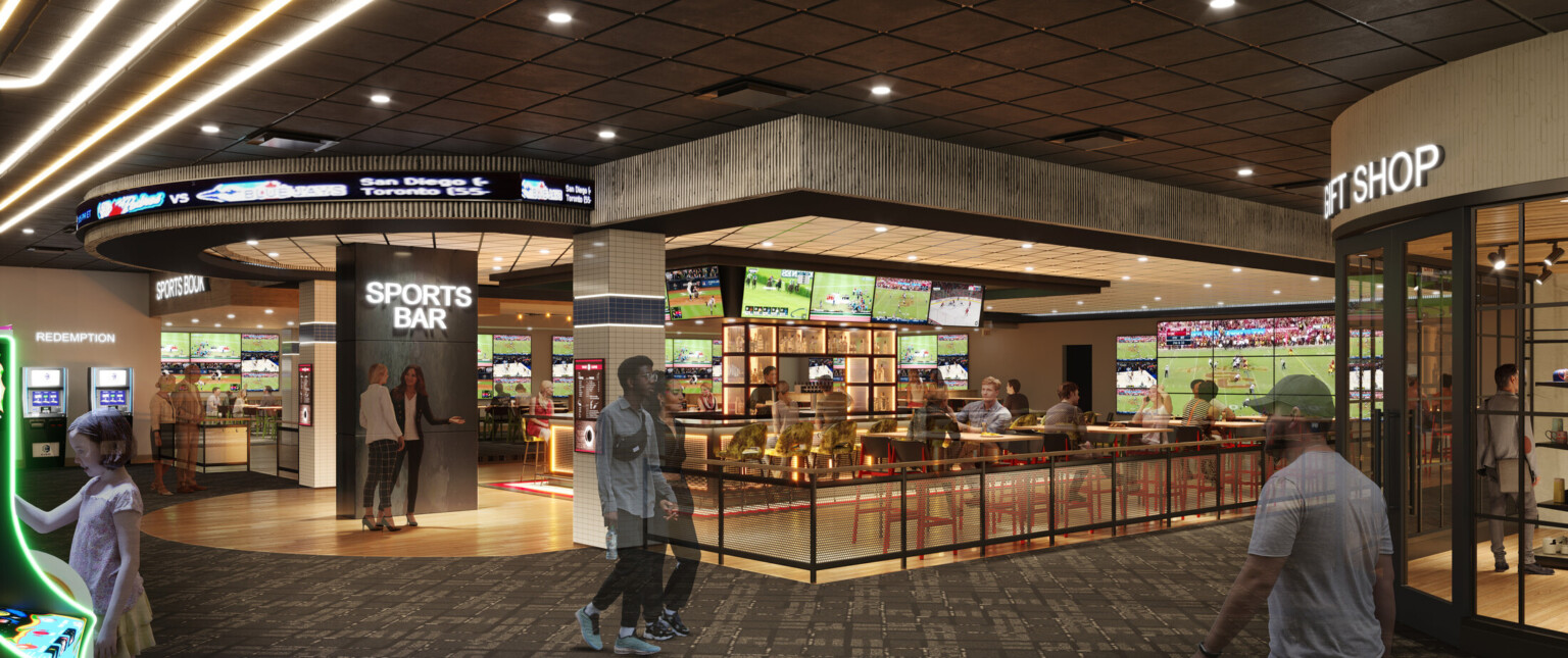 Grey flooring, lighted signs, filled with TV's and seating areas.