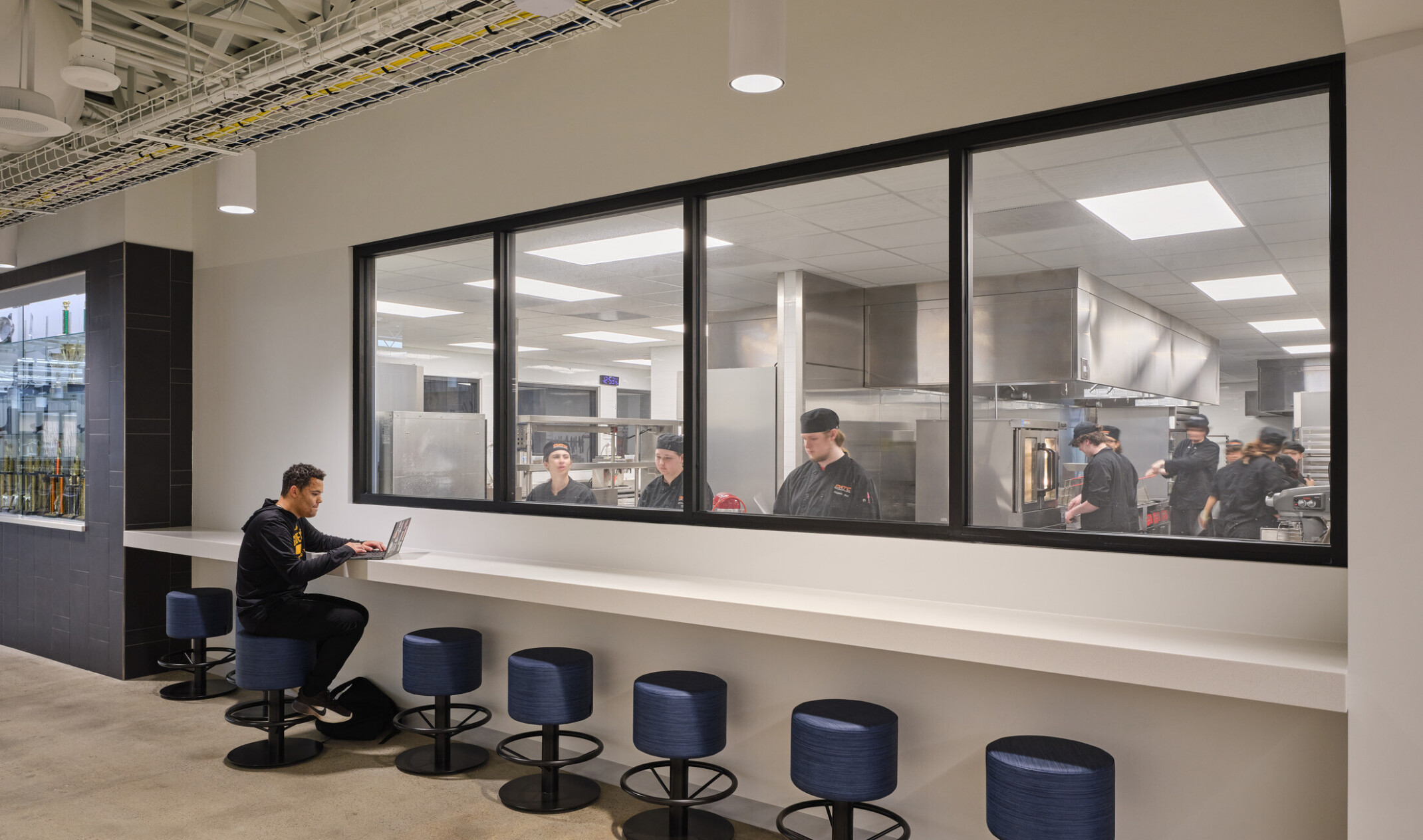 culinary prep space in the olathe innovation center; student counter faces a glass window into a simulation kitchen for career learning in culinary arts