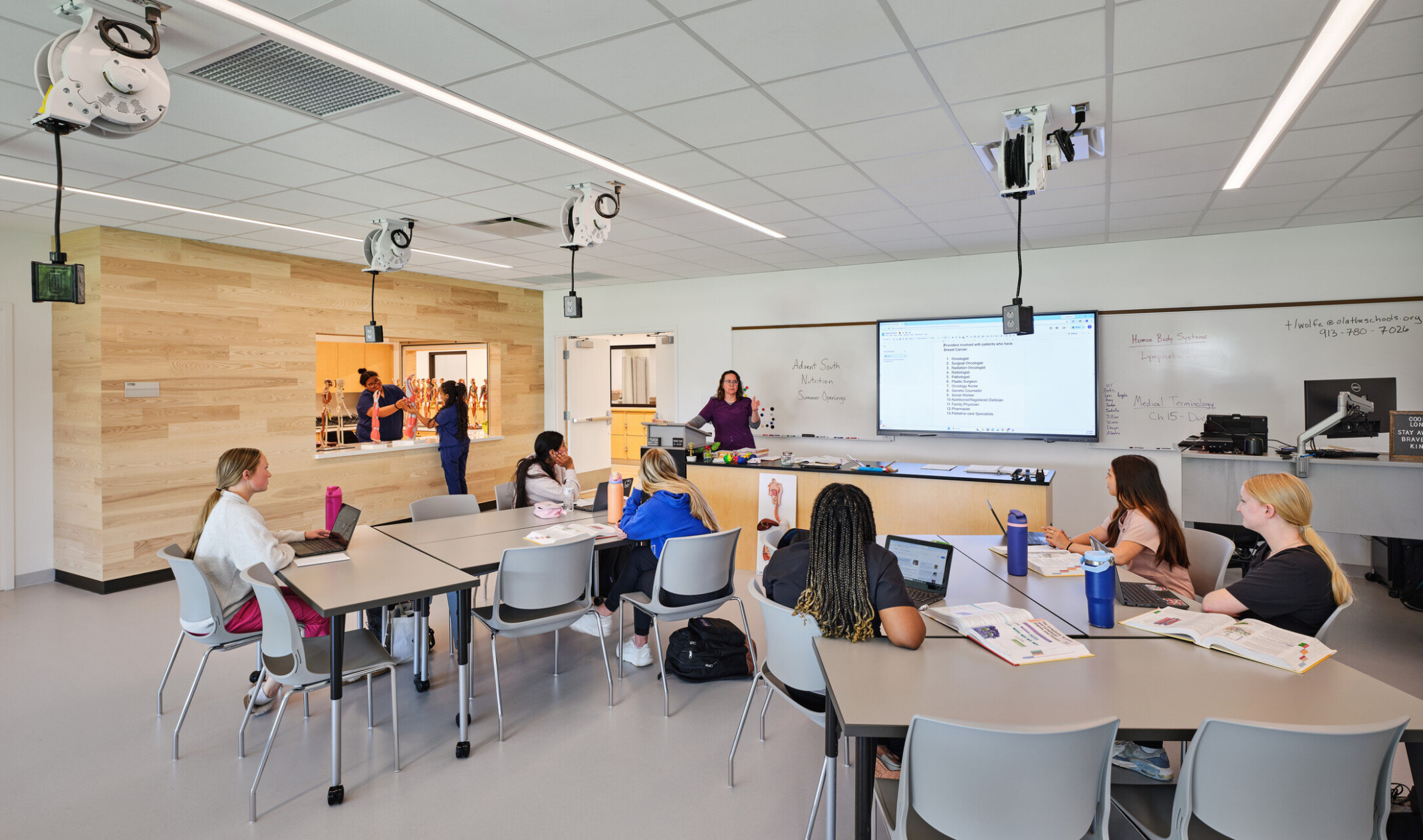 technical classroom in Olathe Innovation center; students desk clumps facing a lecture desk with technology throughout