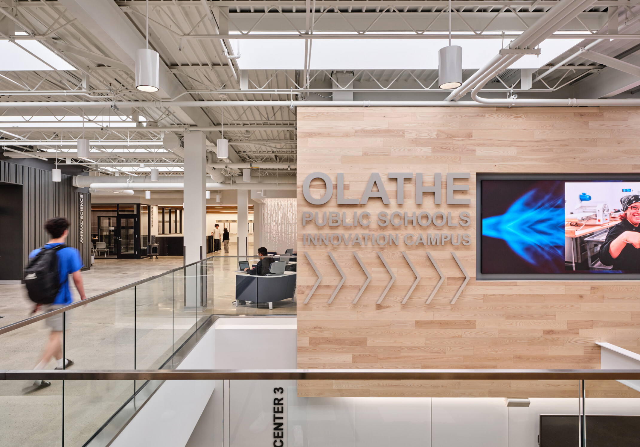 community study space in Olathe Innovation center with TVs on the wall and a communal seating space in the background