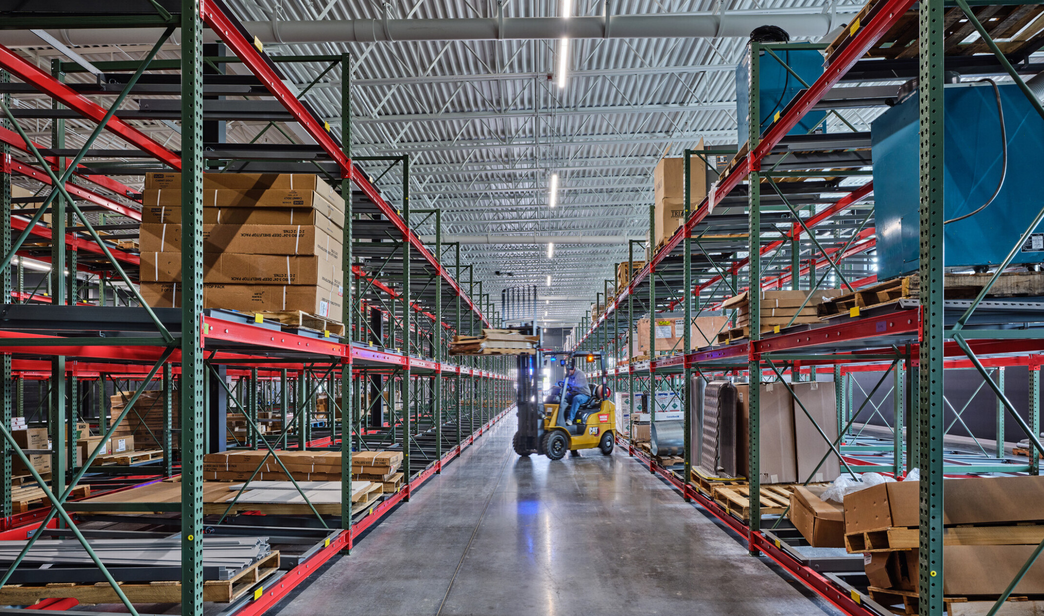 technical classroom in Olathe Innovation center; students working in a warehouse with specialized tools