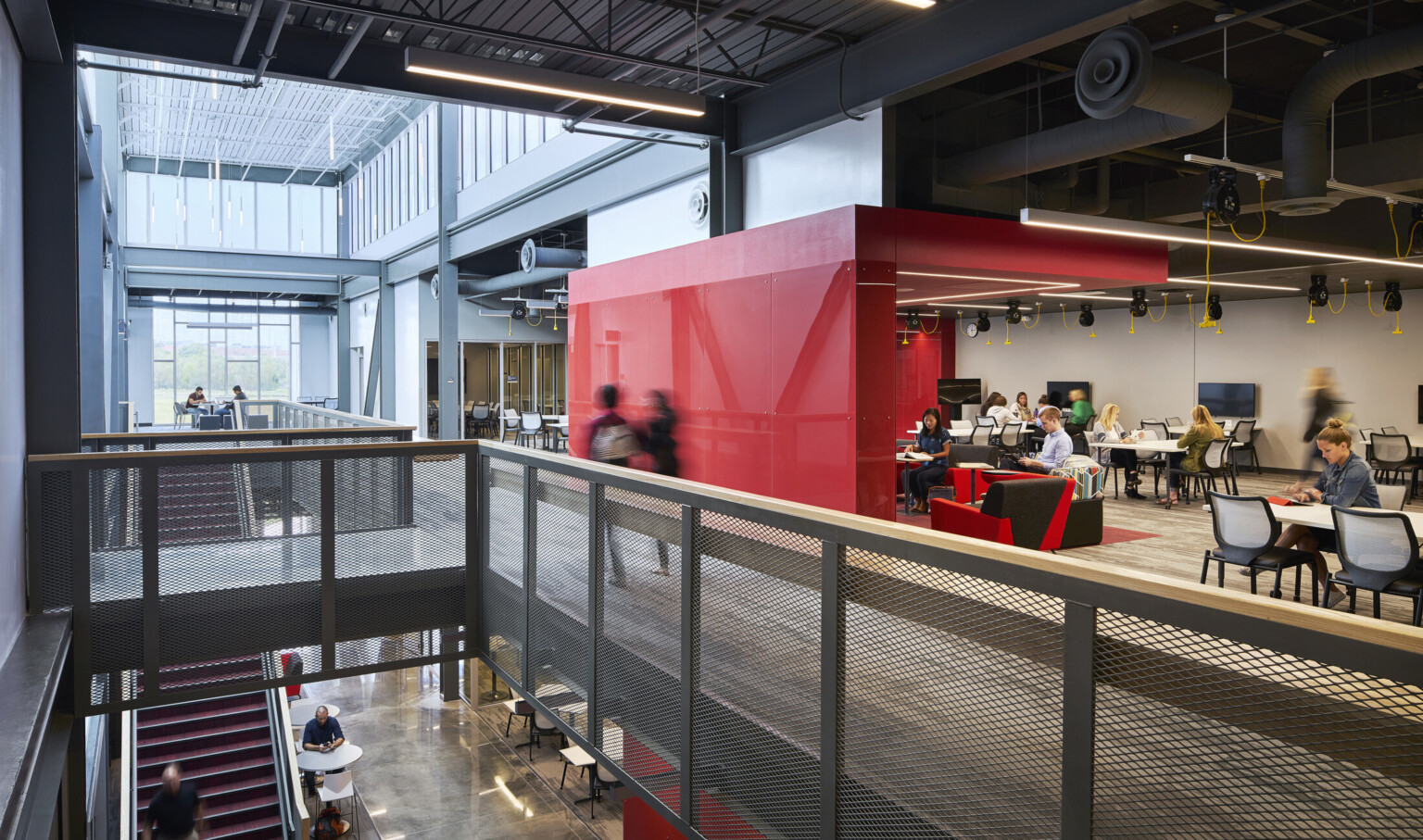 second floor collaboration learning area with breakout nodes and a large red architectural divider at the missouri innovation campus