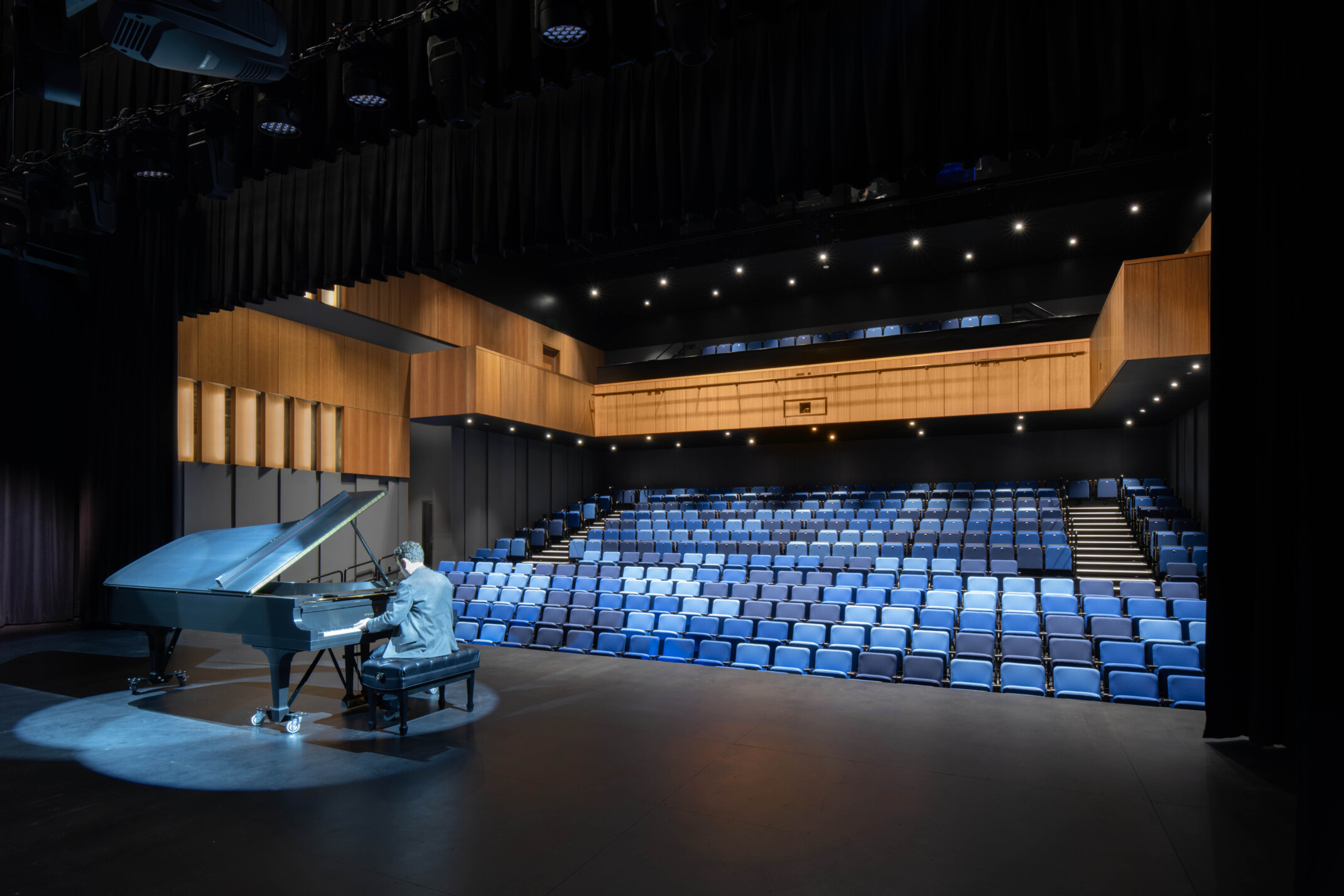 the mass timber stage opens to the outside and serves a 1,500-seat amphitheater designed to support indoor, outdoor, and simultaneous indoor/outdoor events