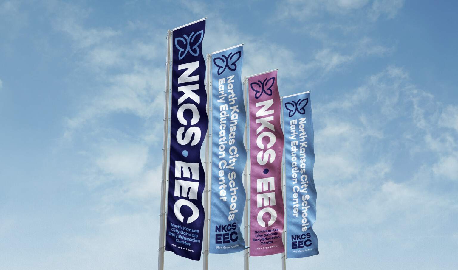 blue and purple vertical banners with white lettering against a blue sky blue and purple vertical banners with white lettering against a blue sky