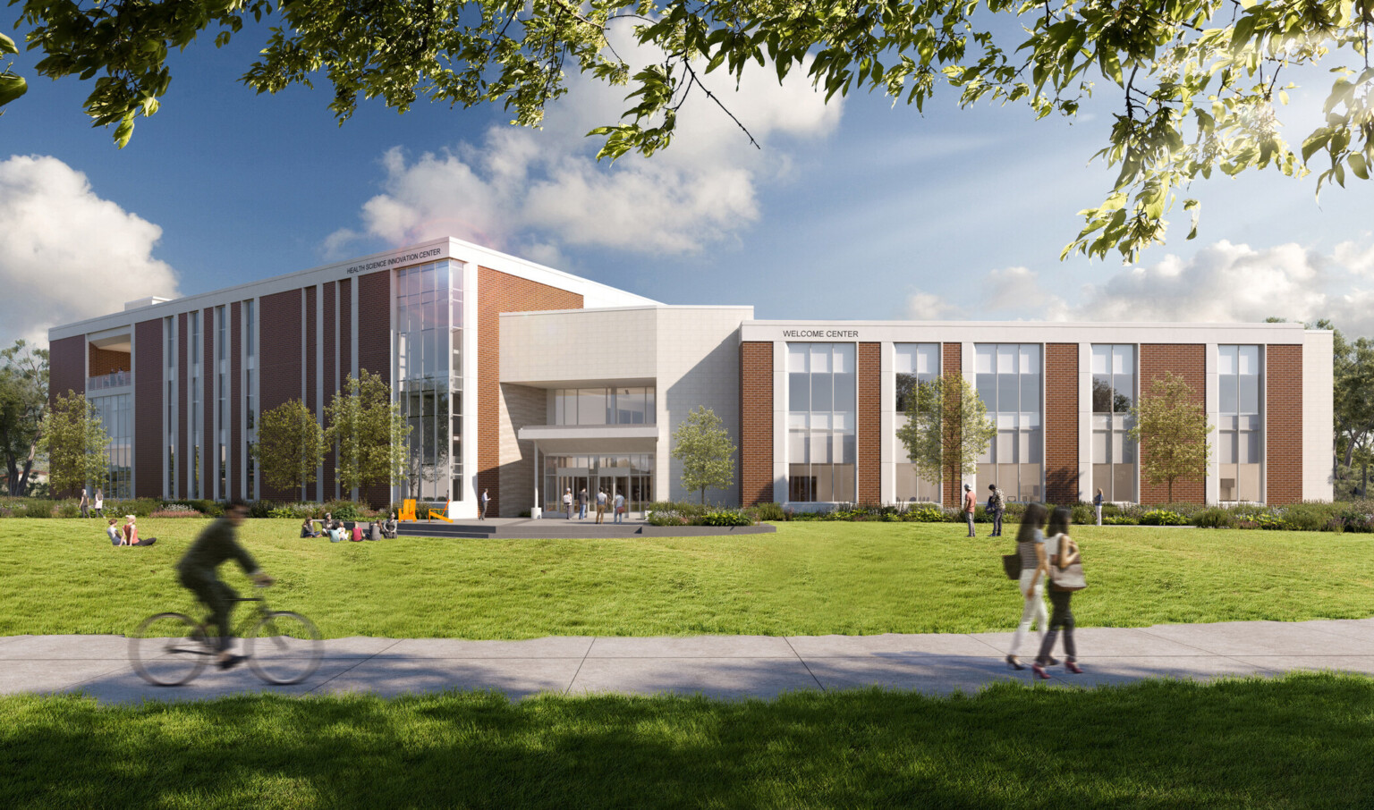welcome center and innovation center at MSSU; students and professors converse on the large lawn out front, vertical windows and columns line the facade; traditional brick blends with modern design