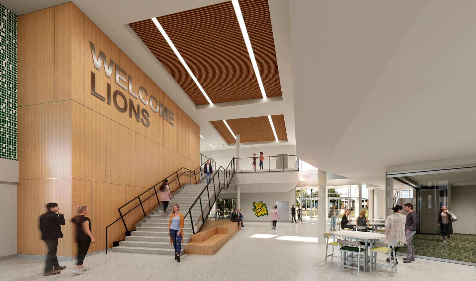 College common area with a wooden wall featuring WELCOME LIONS above a staircase, wooden ceiling with long rectangular lights, and people interacting