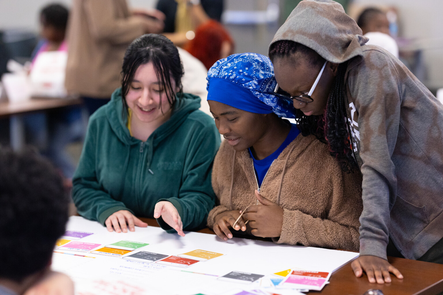 three students at a workshop for community engagement; student engagement and student-led design