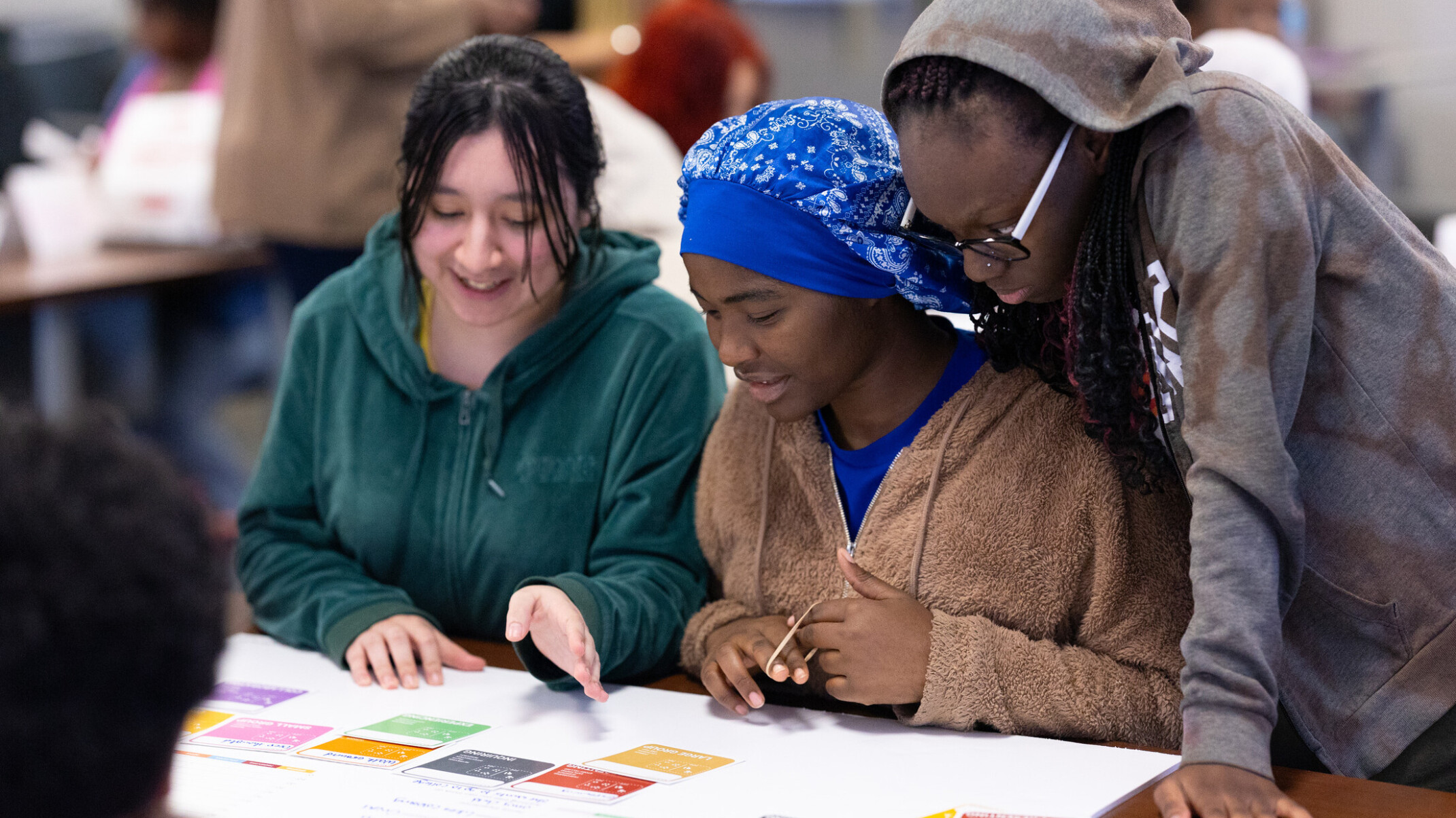 three students at a workshop for community engagement; student engagement and student-led design