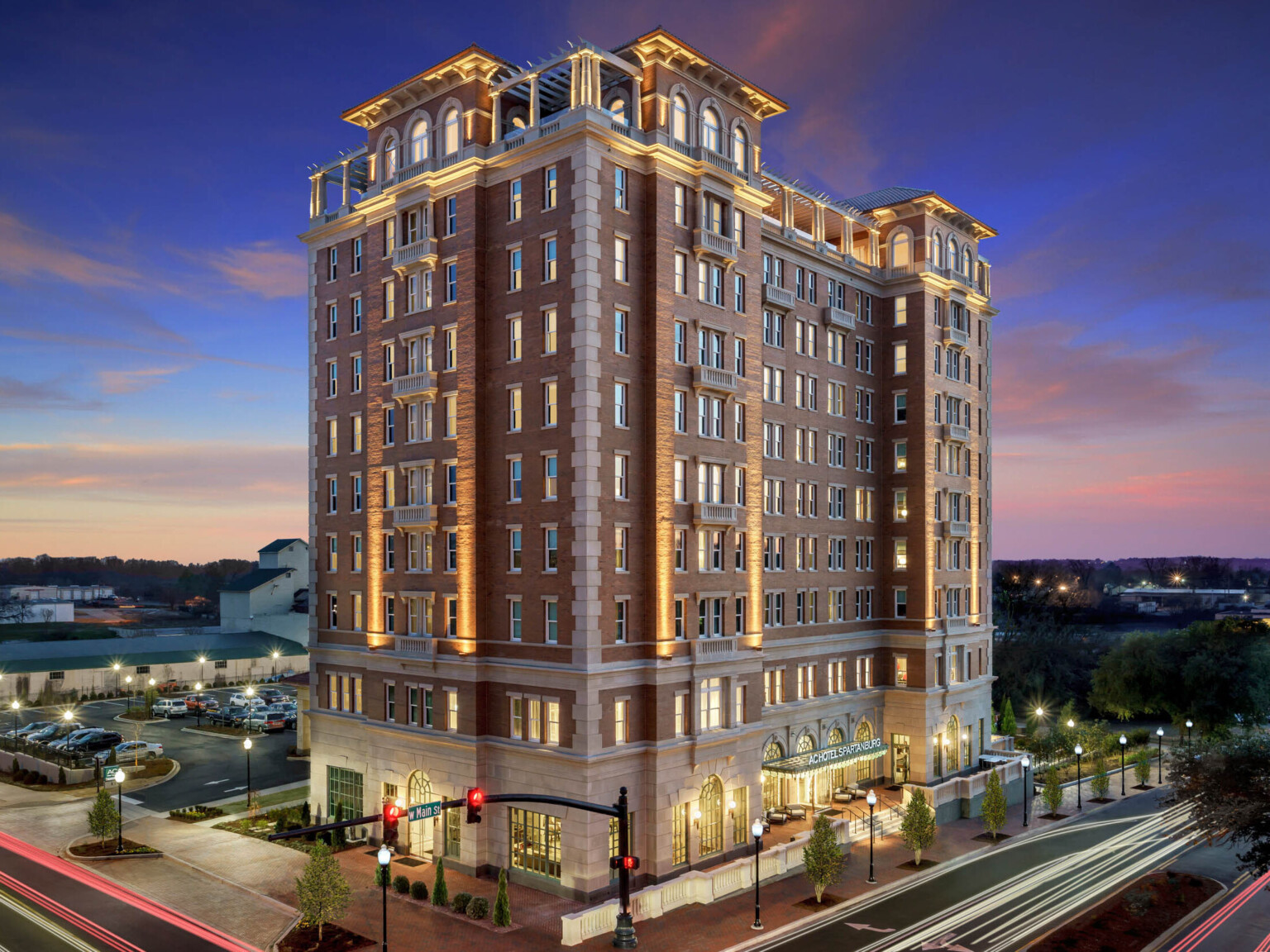 Exterior of building from aerial corner view. Main entry is to the right, with a parking lot behind the 10 story building following Marriott brand architecture