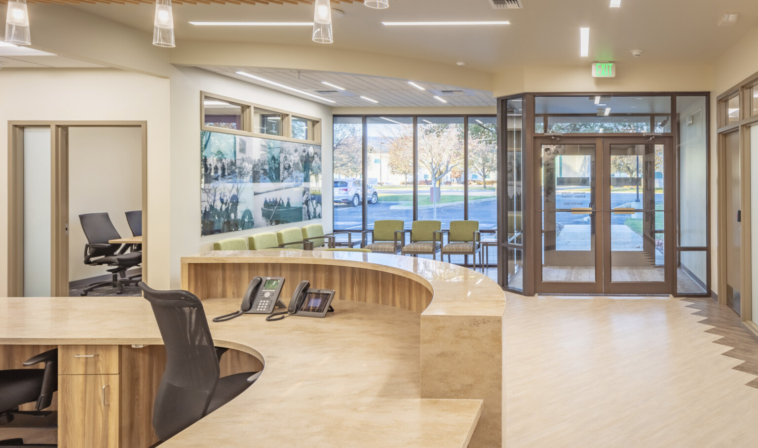 welcome desk at an infusion center with a stone front desk and warm woods