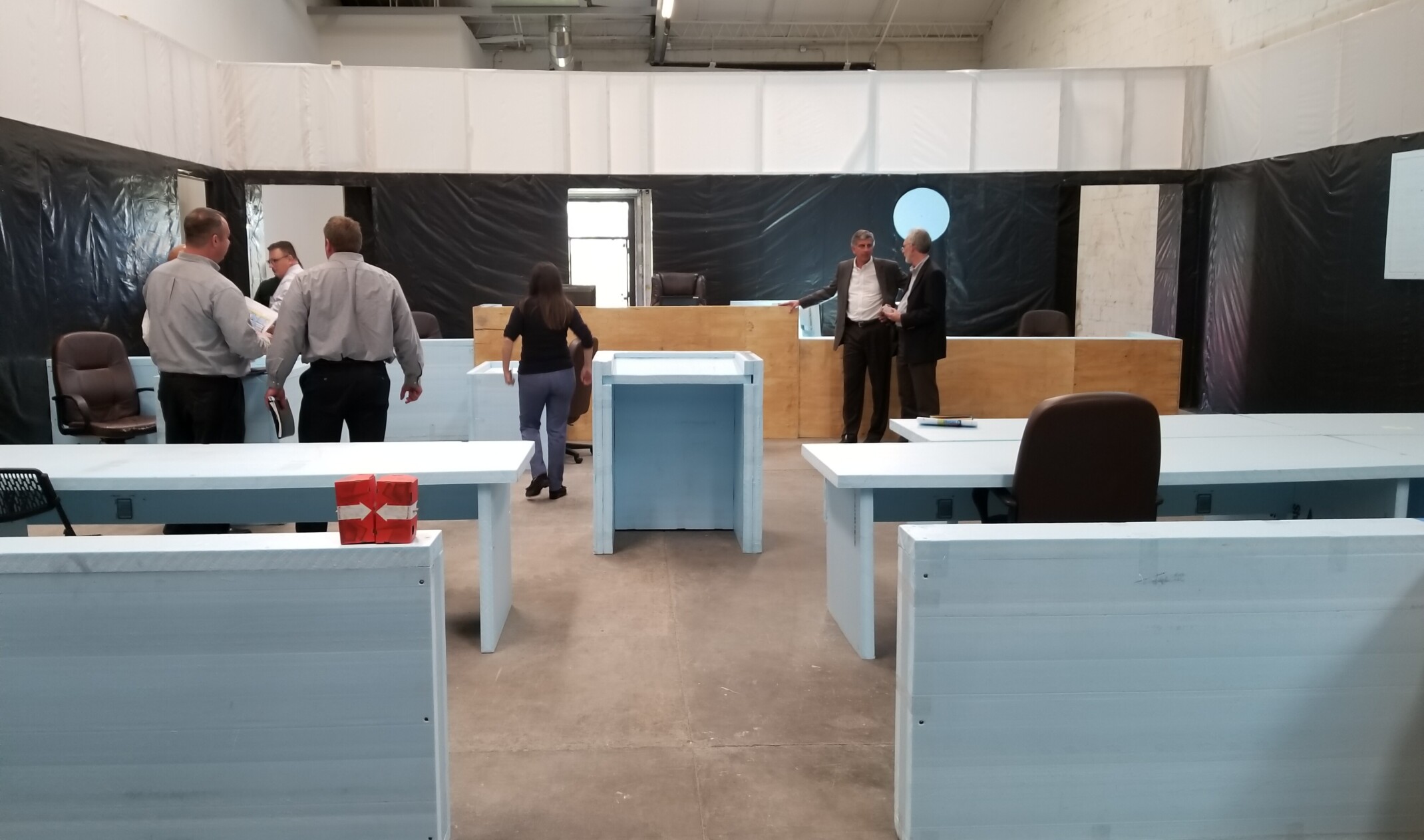 functional mockup of courtroom with people studying the space