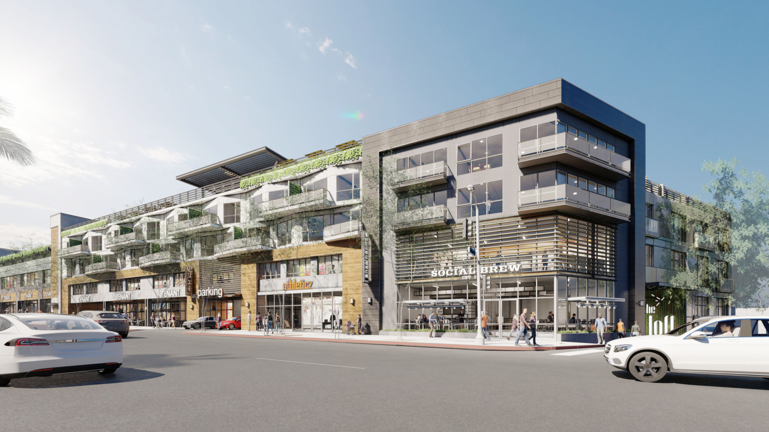 8600 Santa Monica Blvd viewed from street. White and brown 3 story building with grey wrapped facade and overhanging balconies