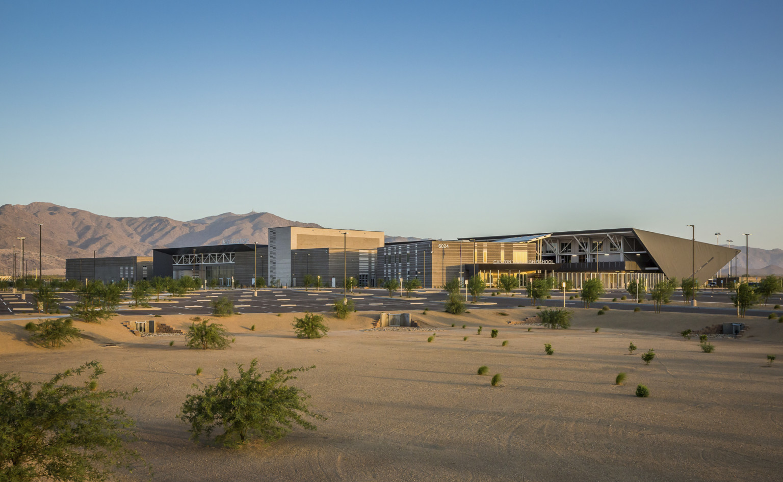 Exterior view of Canyon View High School, an angular multistory building with black wrapped roof to back