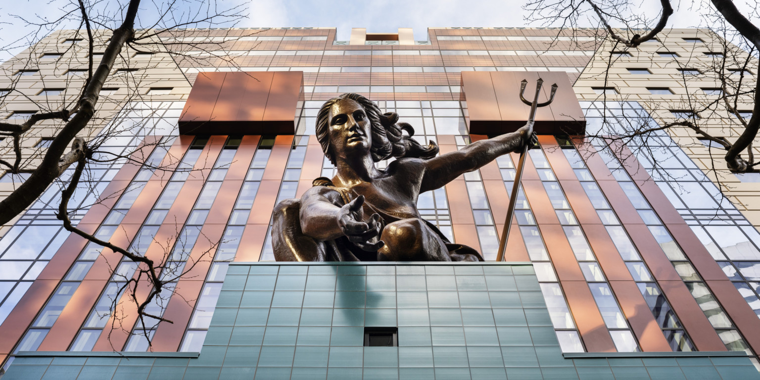 Looking up at the copper repoussé statue of Portlandia above the teal tiled entryway of The Portland Building