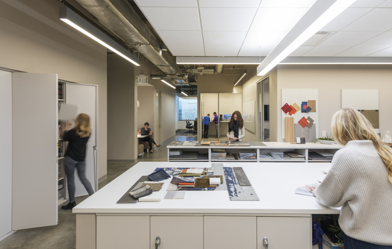 interior design studio with materials library, cabinets, large white table with ample lighting for design collaboration