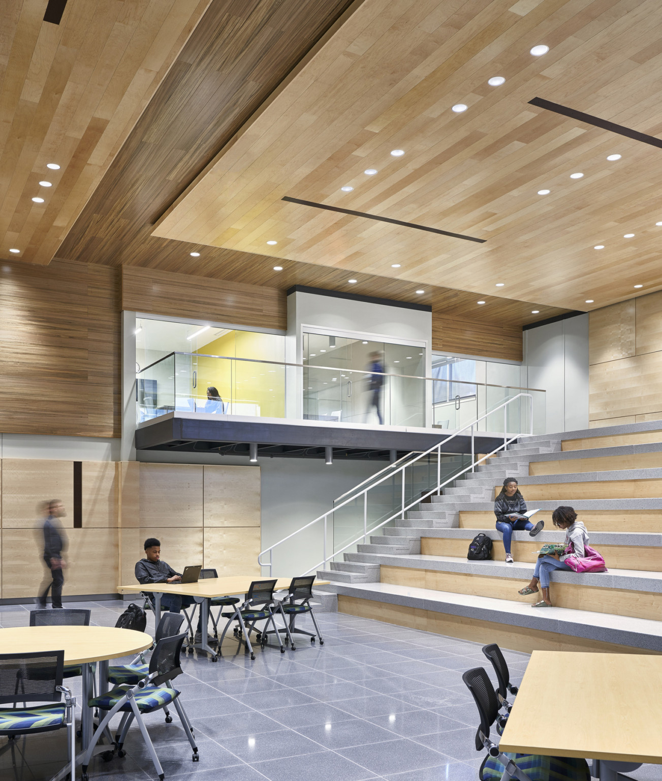 Topeka Center for Advanced Learning & Careers double height interior wood panel room with learning steps to 2nd floor hallway