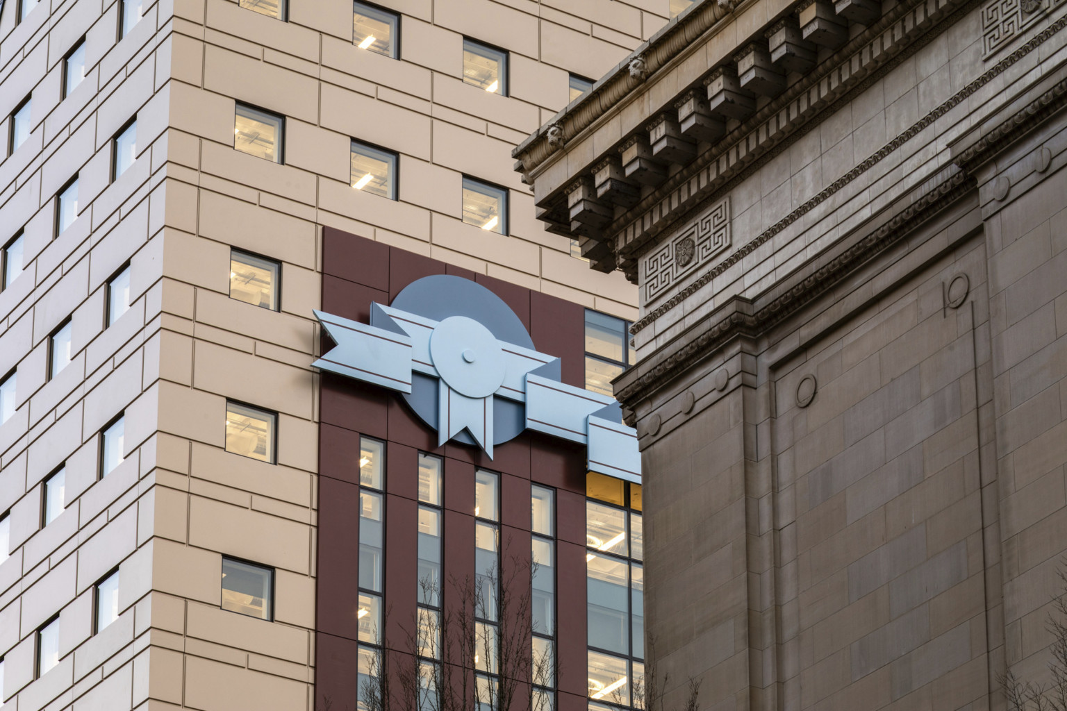 Stone facade and red stripe design with blue 2 tone ribbon shaped details at The Portland Building