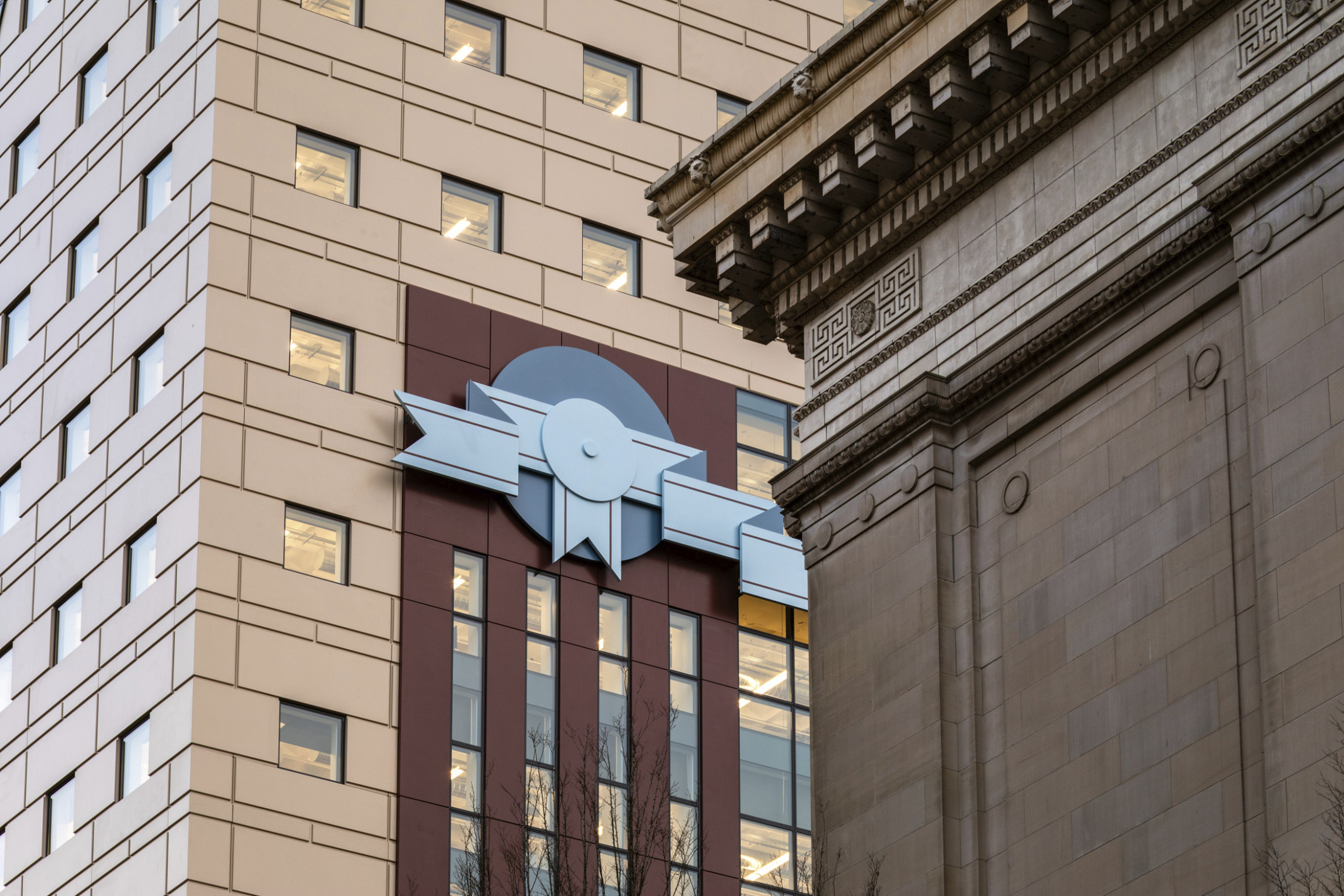 Stone facade and red stripe design with blue 2 tone ribbon shaped details at The Portland Building