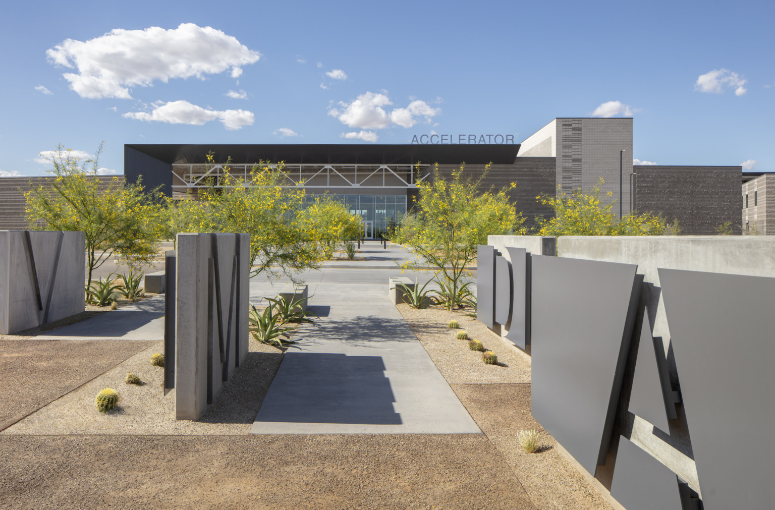 Canyon View High School viewed from across a courtyard with lettered overlaid and imprinted onto cement wall blocks