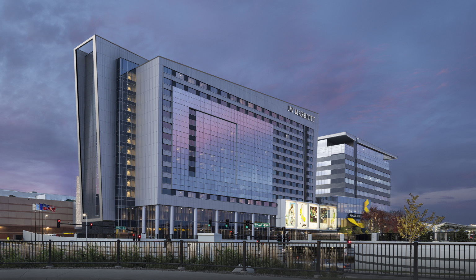 Hotel seen from side from across the street. Elevated outcropped section, while recessed section extends left at angle