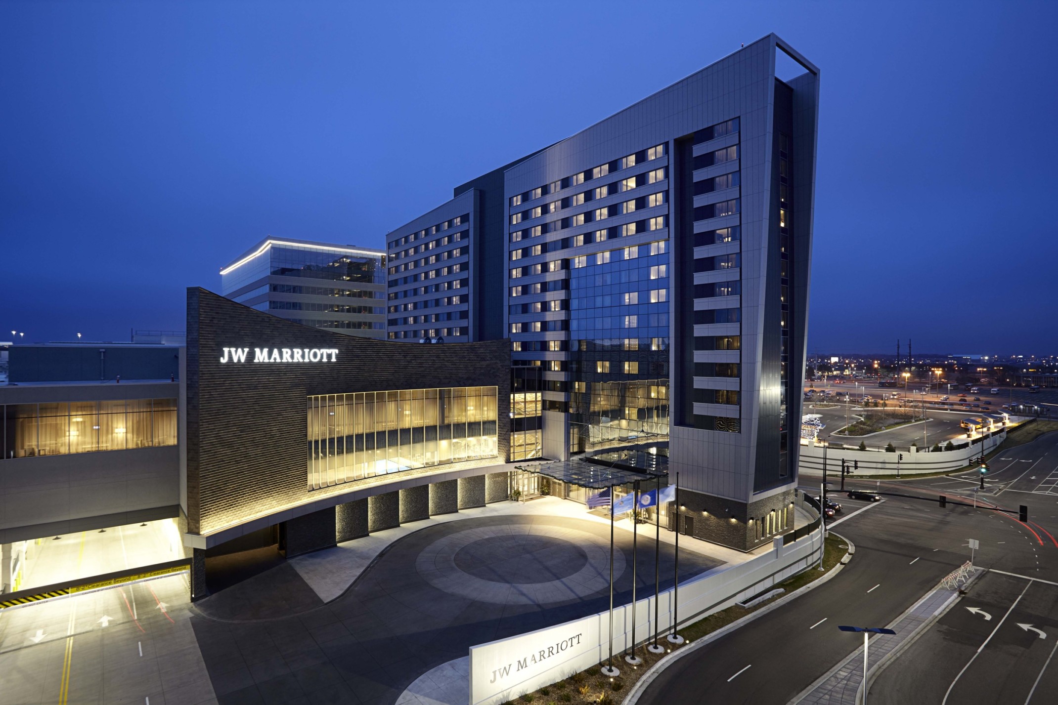 The JW Marriott Hotel and Mall of America illuminated at night. Sign lit on dark wall above double height windows