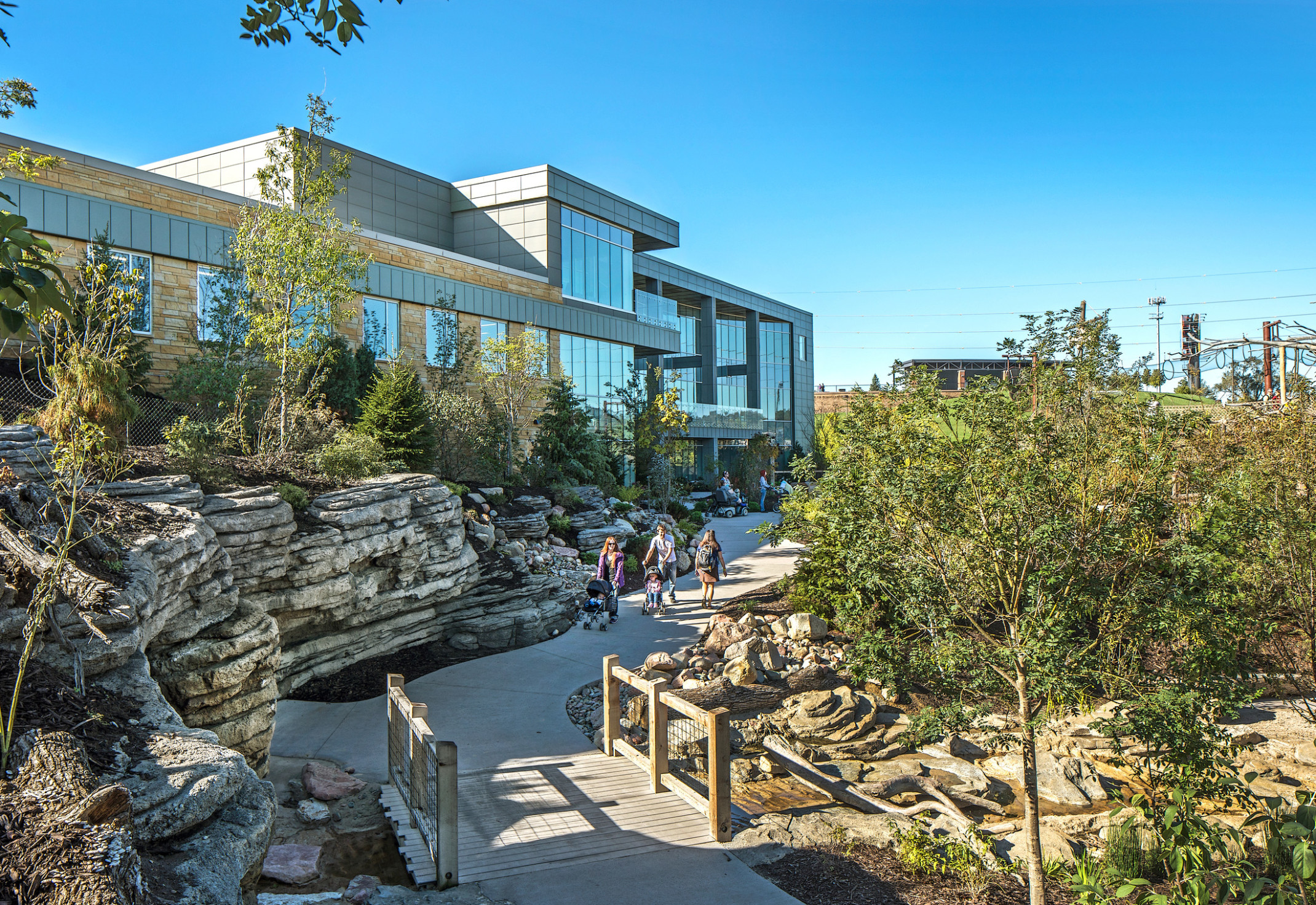 The Omaha Henry Doorly Zoo Education Building with large windows at the front entry, surrounded by trees